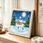 Winter village ice skating punch needle artwork displayed on a table