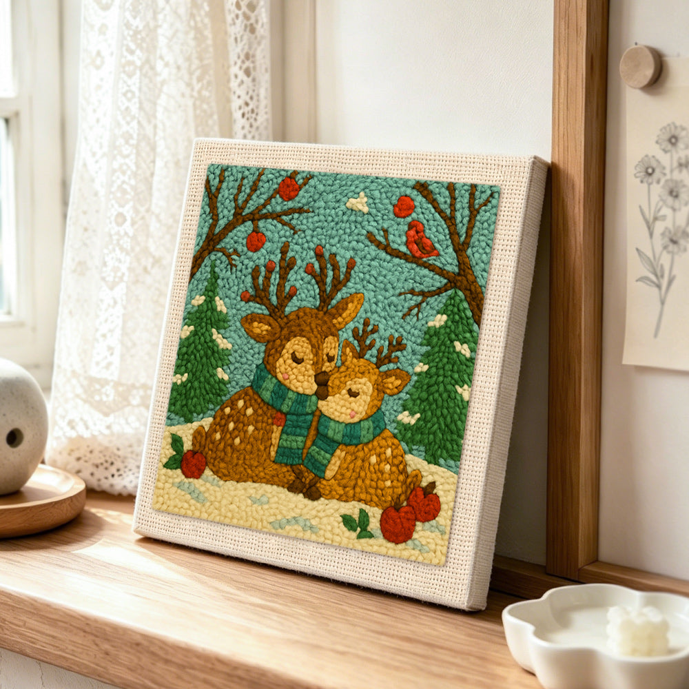 Winter wonderland reindeer with scarves punch needle artwork displayed on a table