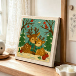 Winter wonderland reindeer with scarves punch needle artwork displayed on a table