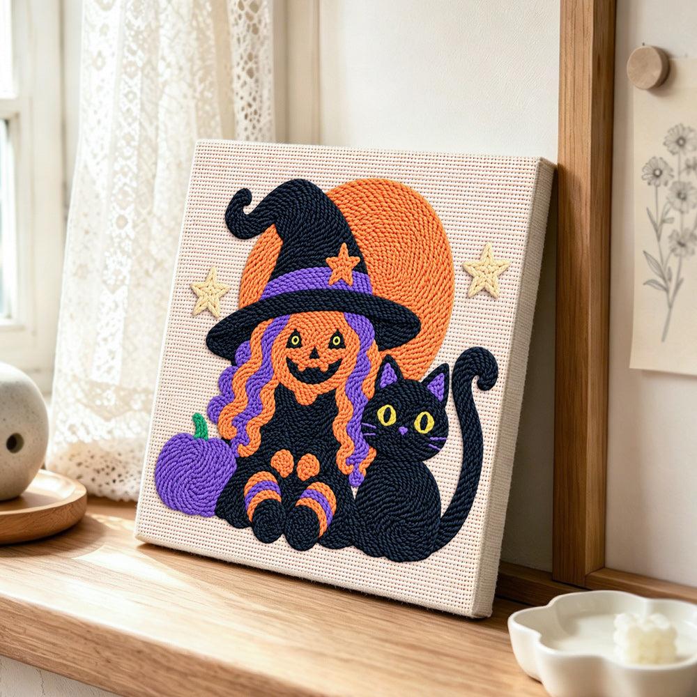 Witch and black cat punch needle artwork displayed on a table