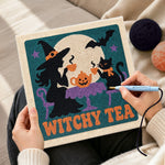 Creating handmade witch and cat having tea punch needle artwork