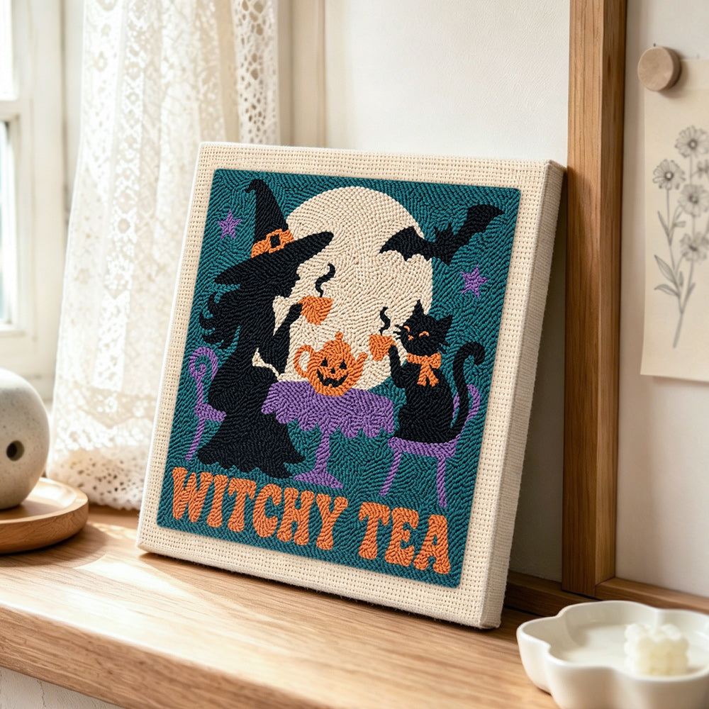 Witch and cat having tea punch needle artwork displayed on a table