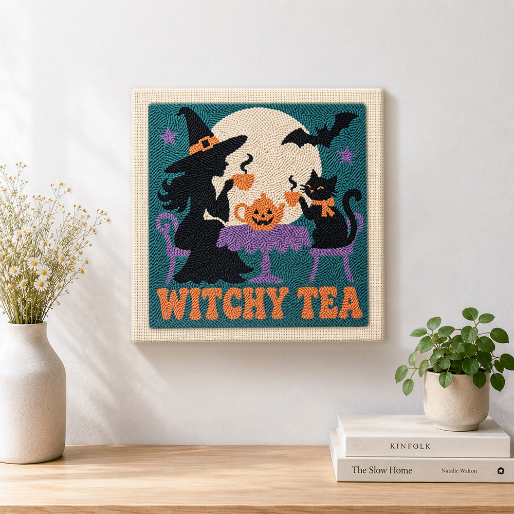 Finished witch and cat having tea artwork displayed on a wall