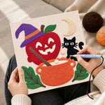Creating handmade witch apple cauldron punch needle artwork