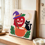 Witch apple cauldron punch needle artwork displayed on a table
