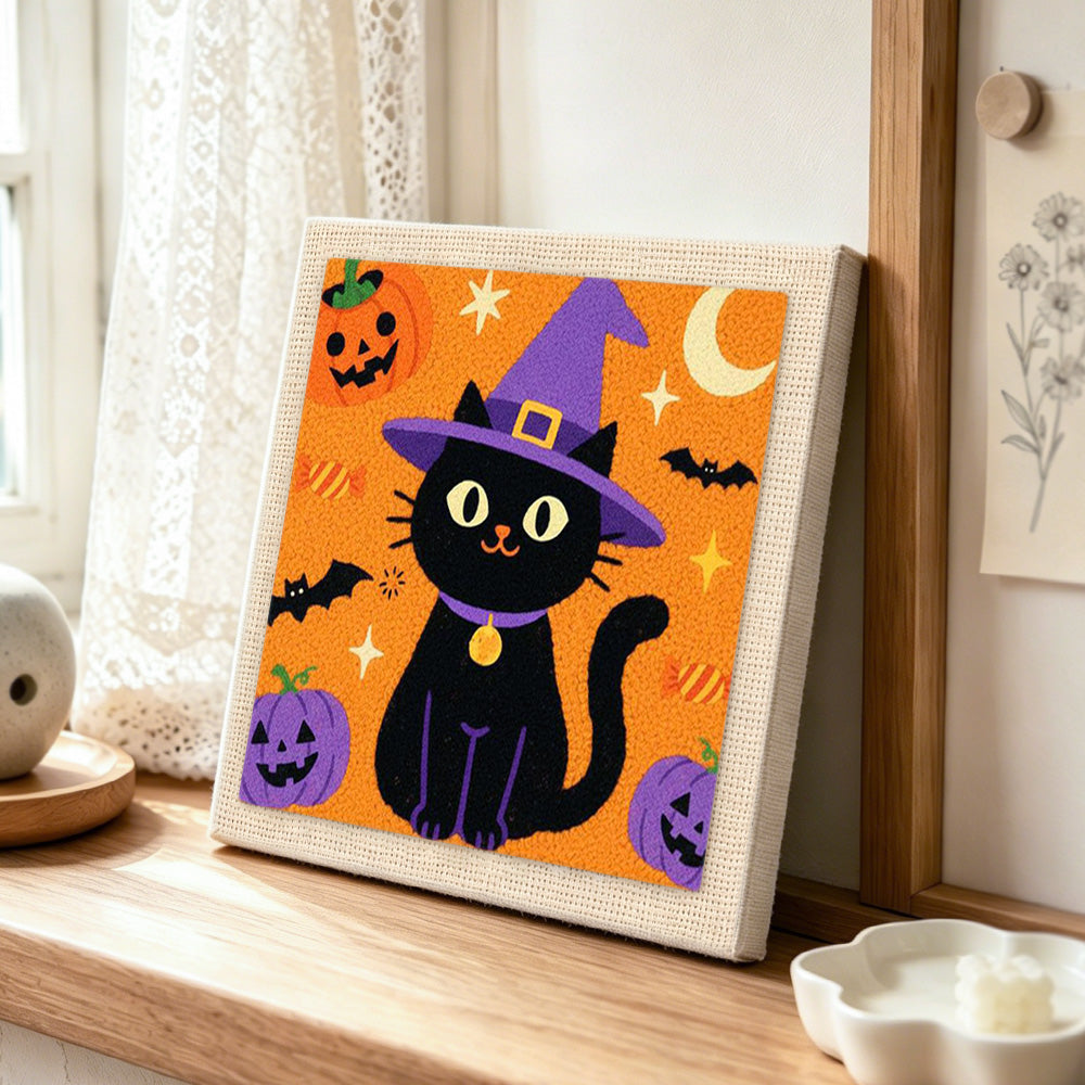 Witch black cat punch needle artwork displayed on a table
