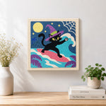 Finished witch black cat surfing under full moon artwork displayed on a wall