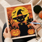 Creating handmade witch black cat with pumpkins punch needle artwork