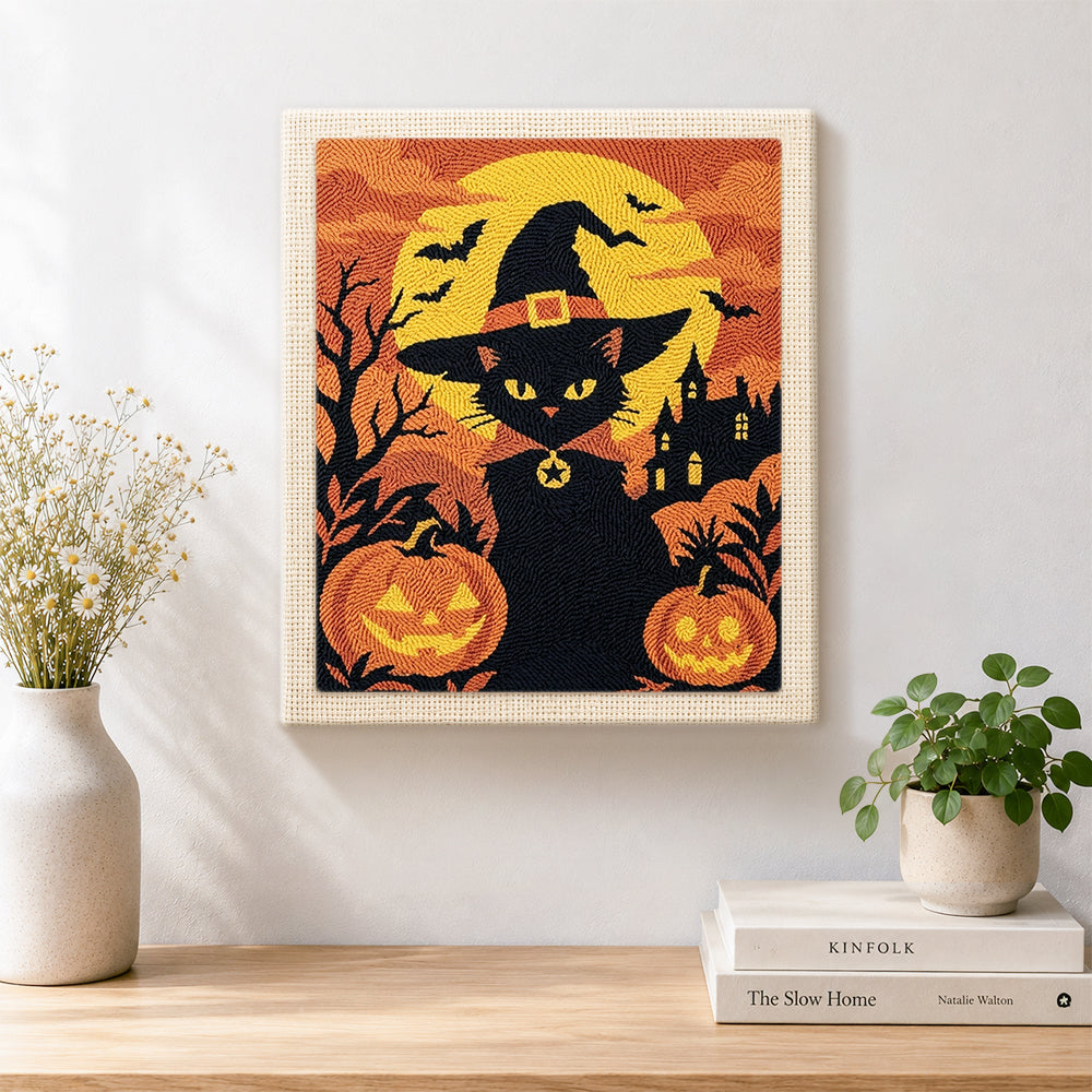 Finished witch black cat with pumpkins artwork displayed on a wall