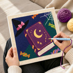 Creating handmade witch book and candies punch needle artwork