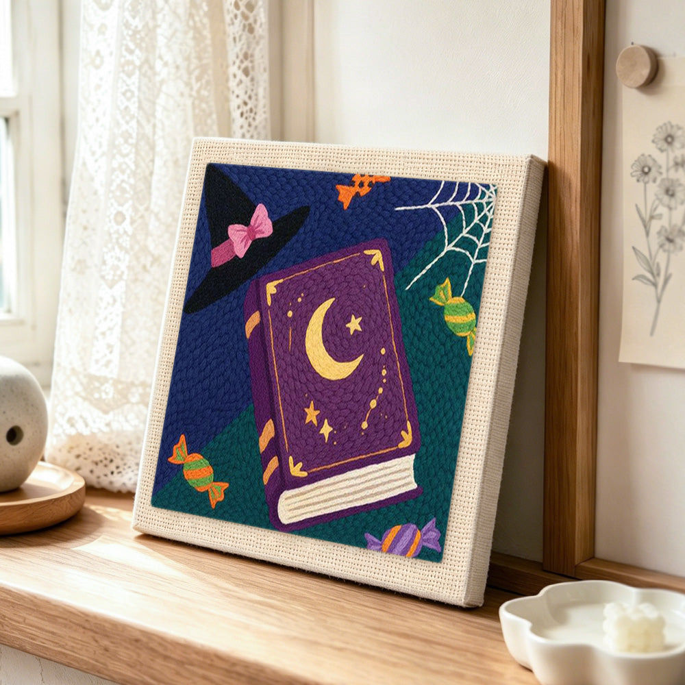 Witch book and candies punch needle artwork displayed on a table