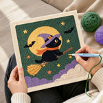 Creating handmade witch cat on broom punch needle artwork