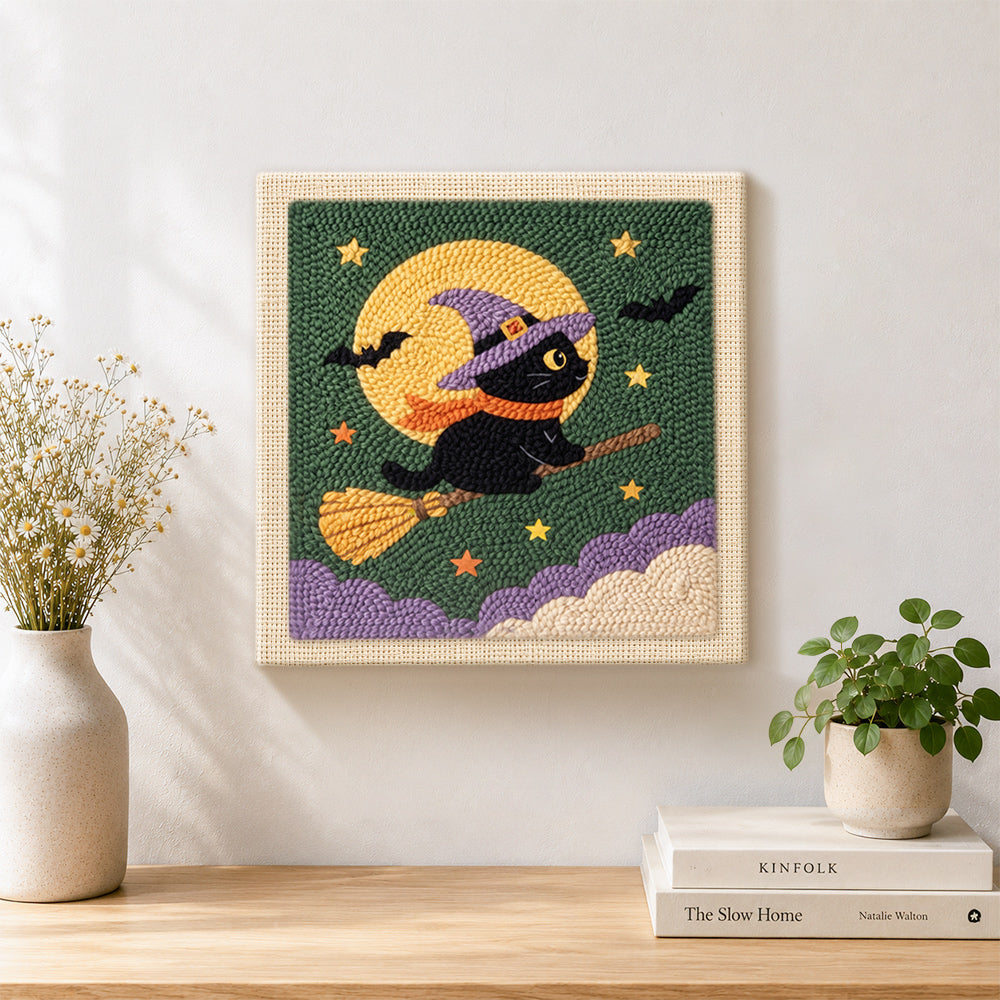 Finished witch cat on broom artwork displayed on a wall