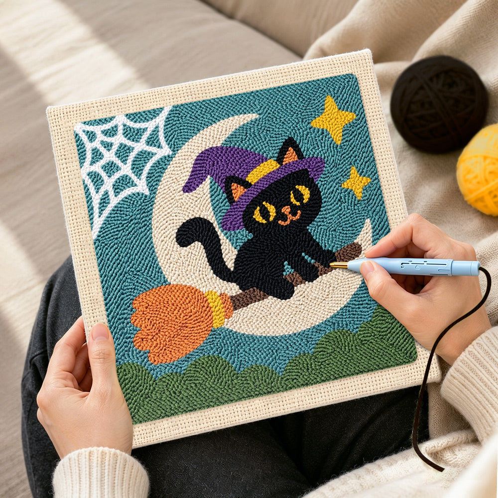 Creating handmade witch cat on broomstick punch needle artwork