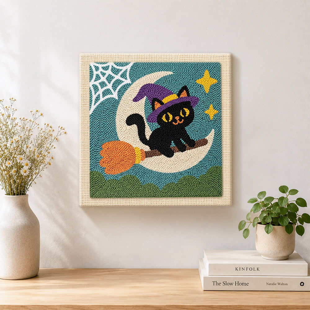 Finished witch cat on broomstick artwork displayed on a wall