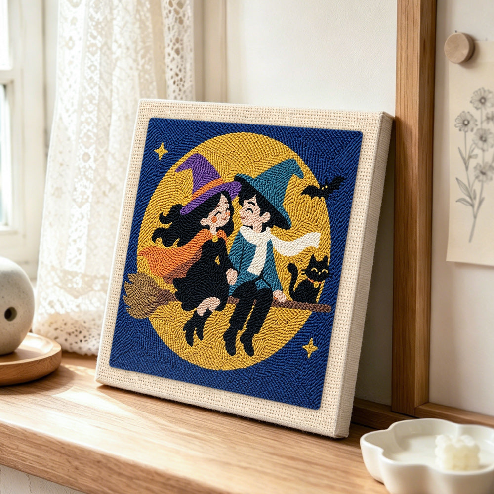 Witch couple moon ride punch needle artwork displayed on a table
