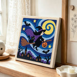Witch flying on broomstick punch needle artwork displayed on a table