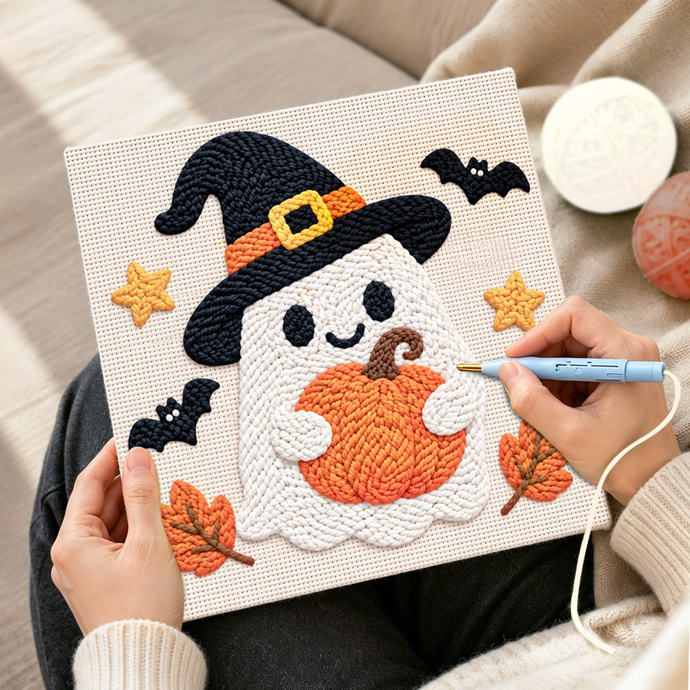Creating handmade witch ghost holding pumpkin punch needle artwork