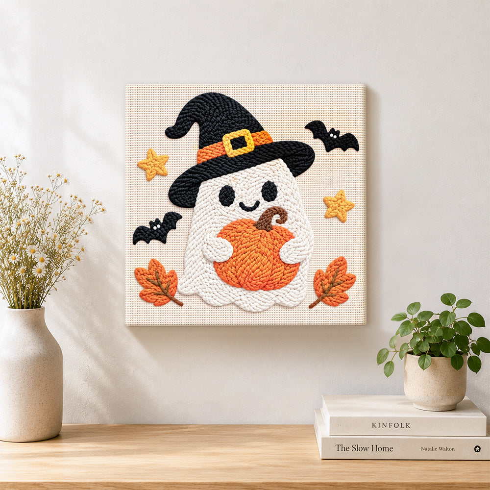 Finished witch ghost holding pumpkin artwork displayed on a wall