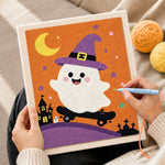 Creating handmade witch ghost on a skateboard punch needle artwork