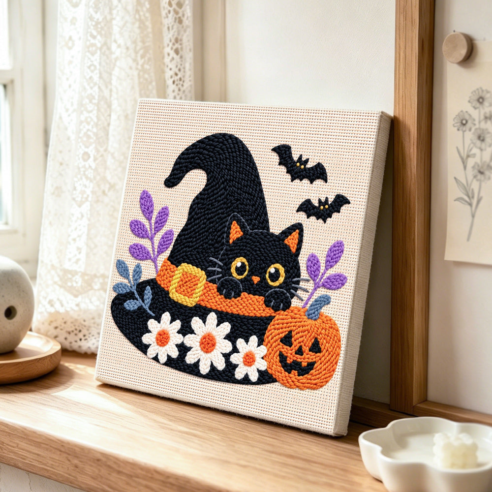 Witch hat black cat punch needle artwork displayed on a table
