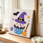 Witch hat cupcake punch needle artwork displayed on a table