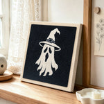 Witch hat ghost punch needle artwork displayed on a table