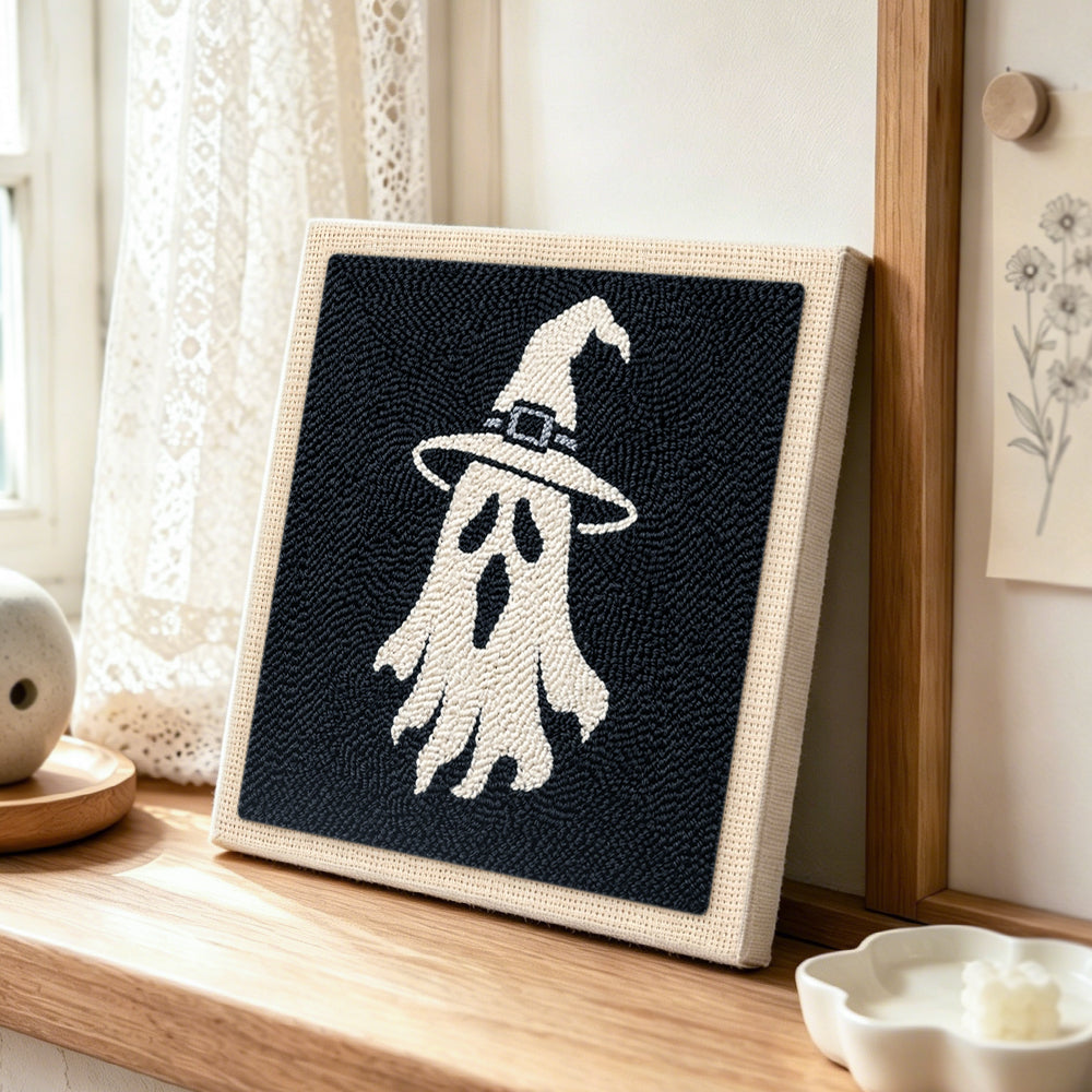 Witch hat ghost punch needle artwork displayed on a table