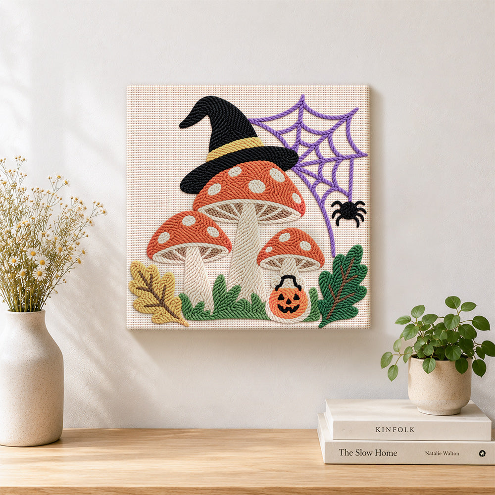 Finished witch hat mushrooms with spider web artwork displayed on a wall