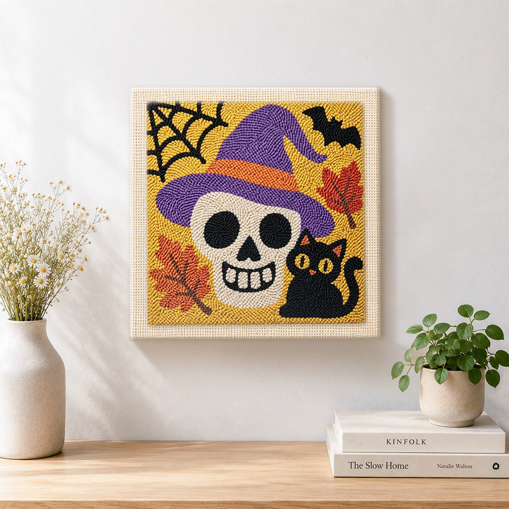 Finished witch hat skull and black cat artwork displayed on a wall