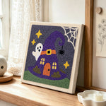 Witch hat tiny house punch needle artwork displayed on a table