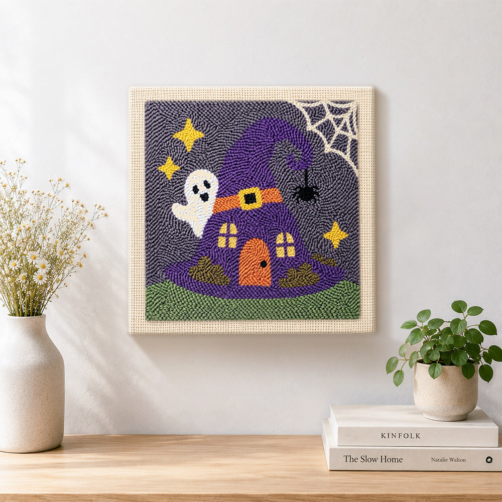 Finished witch hat tiny house artwork displayed on a wall