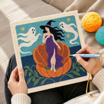 Creating handmade witch in giant pumpkin punch needle artwork