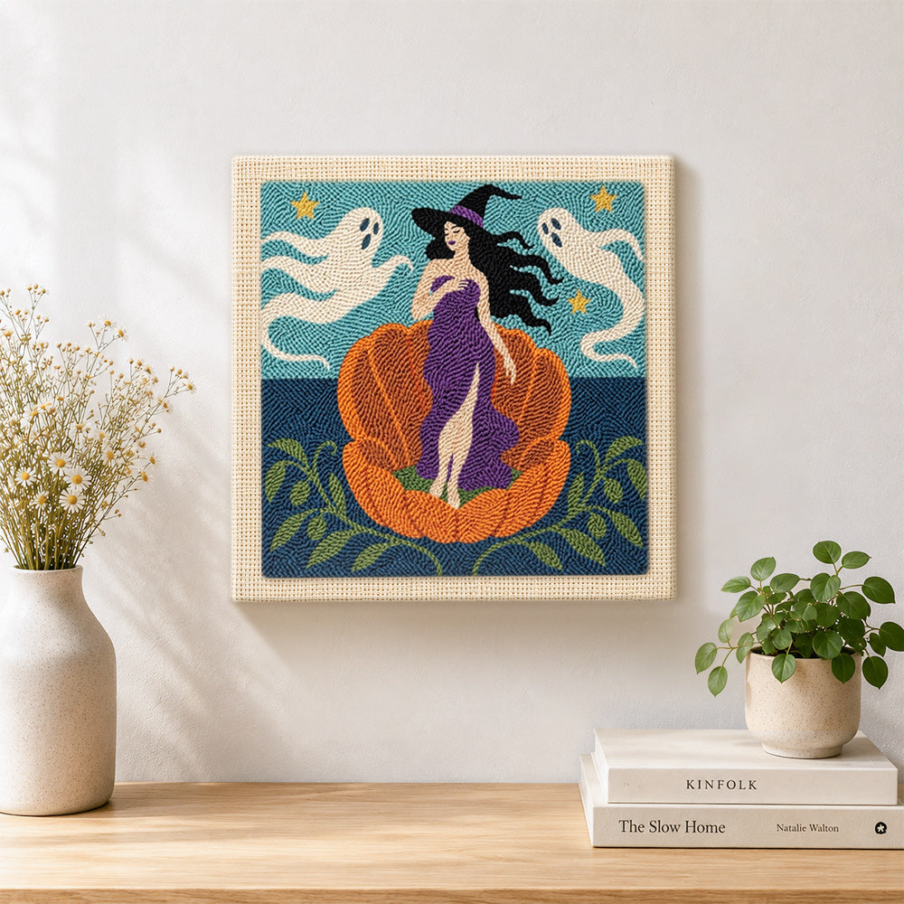 Finished witch in giant pumpkin artwork displayed on a wall