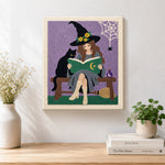 Finished witch reading beside black cat artwork displayed on a wall