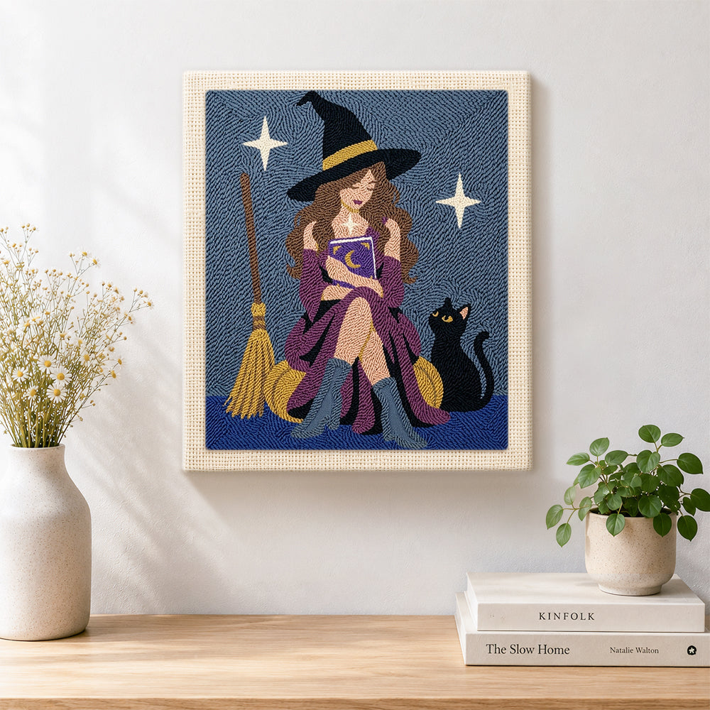 Finished witch reading magic book with cat artwork displayed on a wall