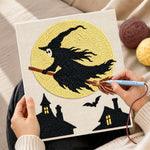 Creating handmade witch silhouette against full moon punch needle artwork