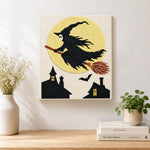 Finished witch silhouette against full moon artwork displayed on a wall