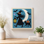 Finished witch silhouette under moon artwork displayed on a wall