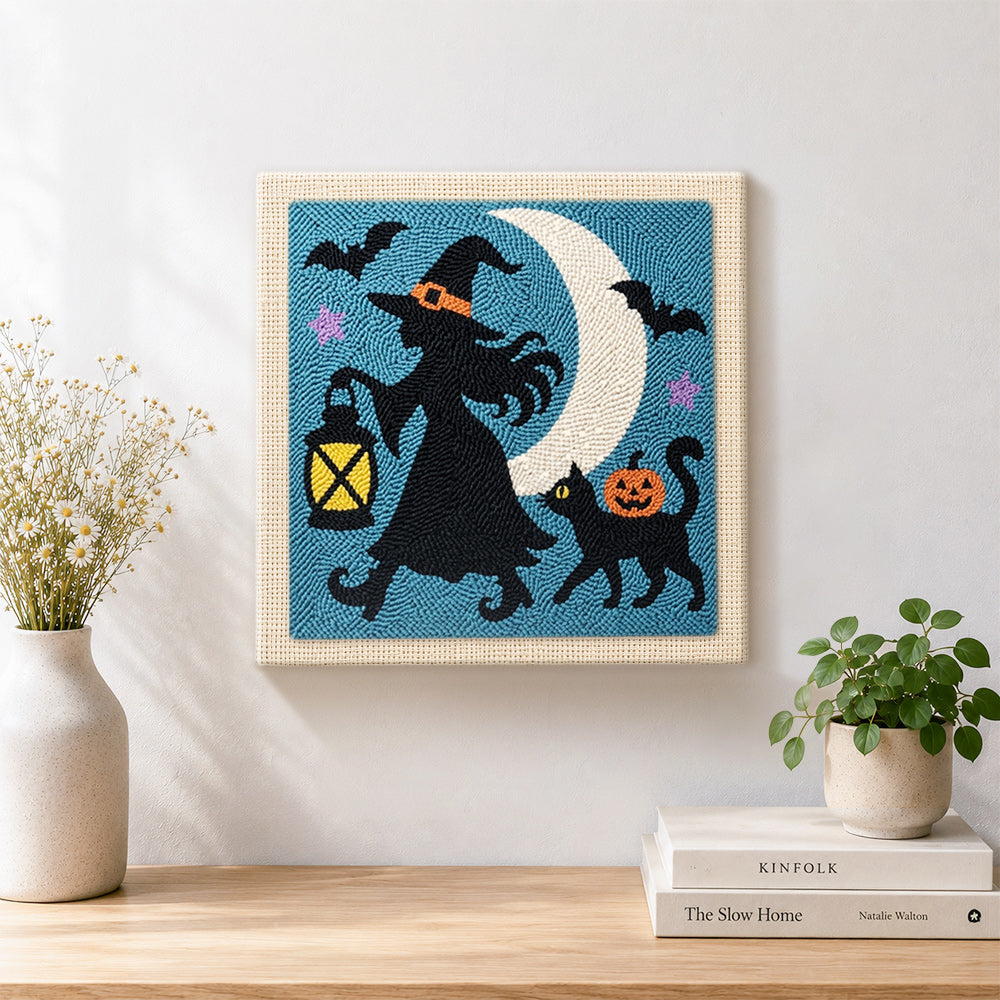 Finished witch silhouette under moon artwork displayed on a wall