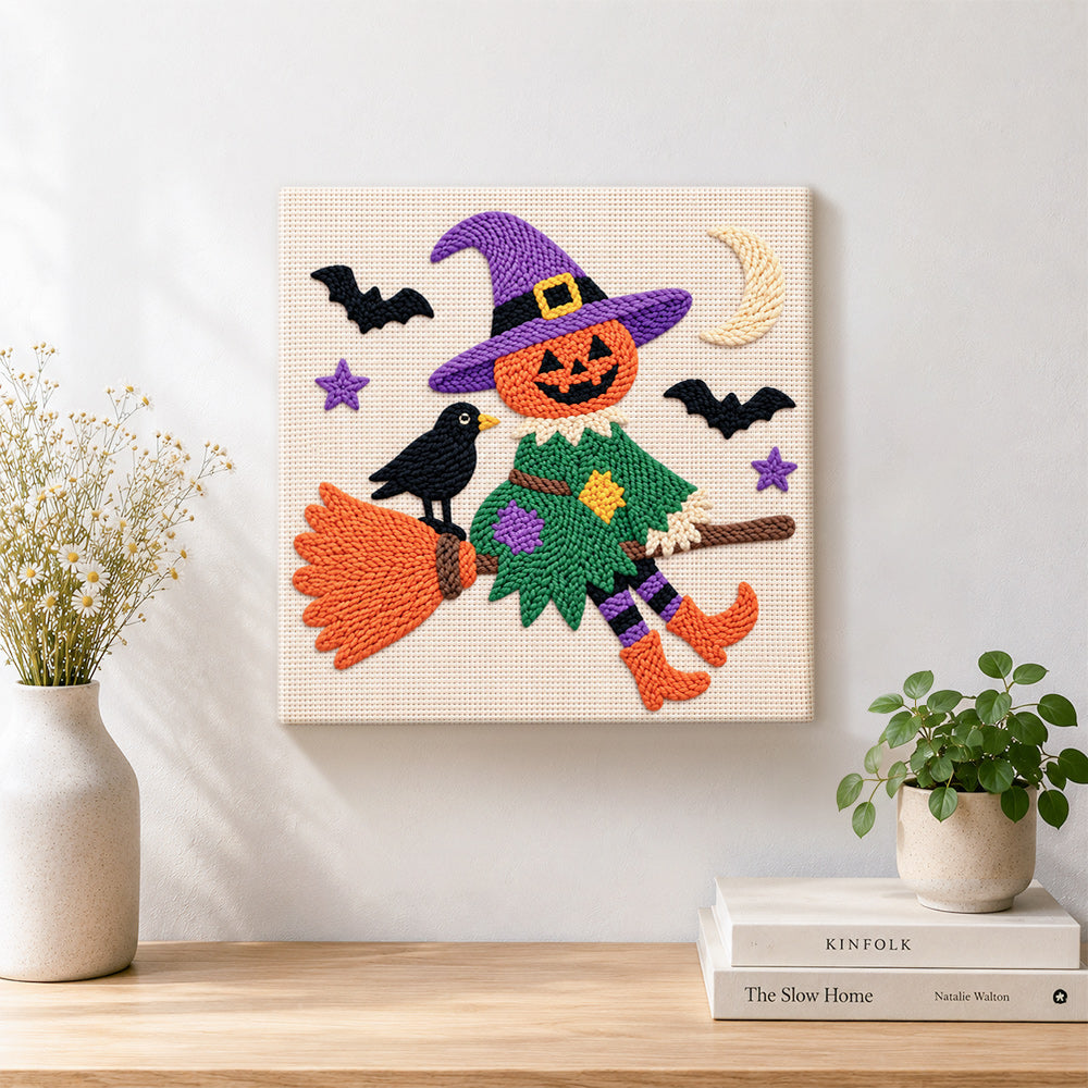 Finished witch soaring with pumpkin artwork displayed on a wall