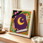 Witch spell book punch needle artwork displayed on a table