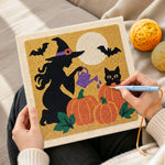 Creating handmade witch watering pumpkins punch needle artwork