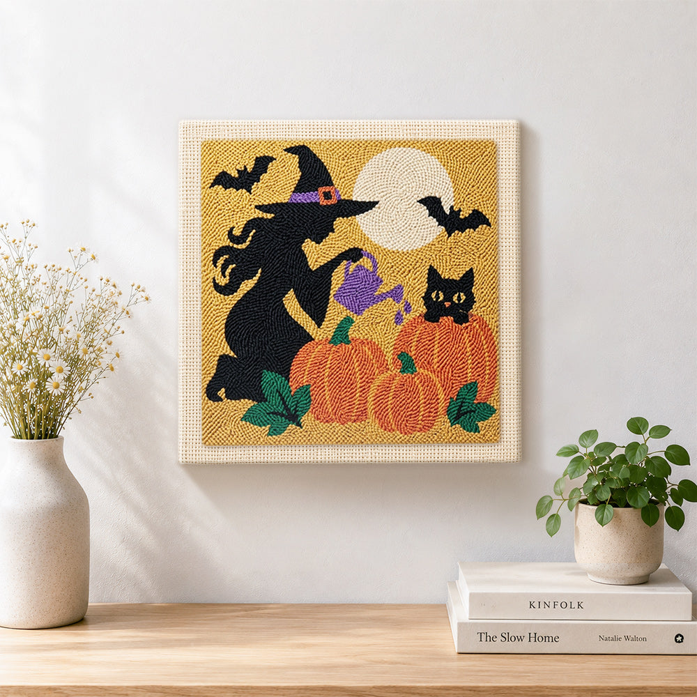 Finished witch watering pumpkins artwork displayed on a wall