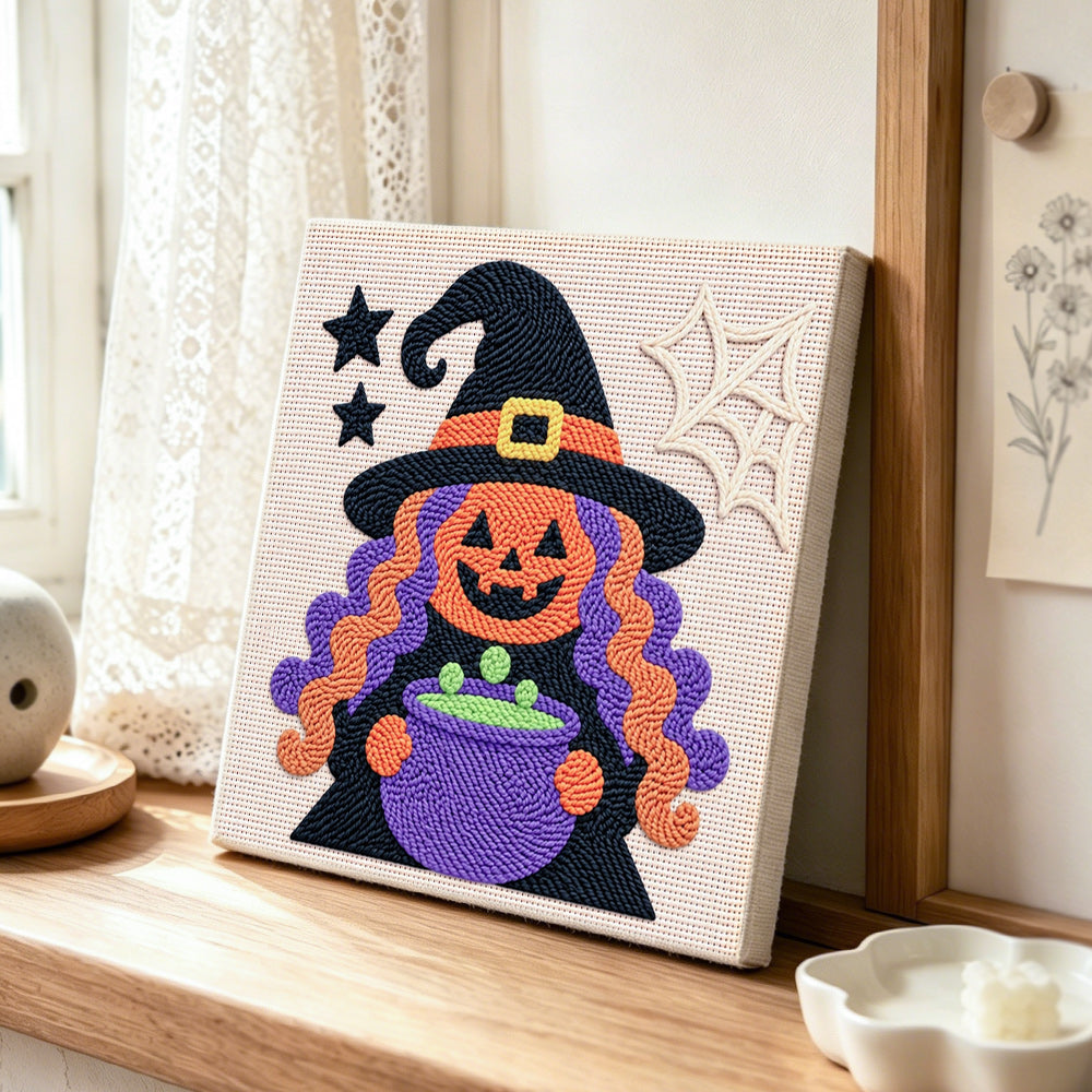Witch with magic cauldron punch needle artwork displayed on a table