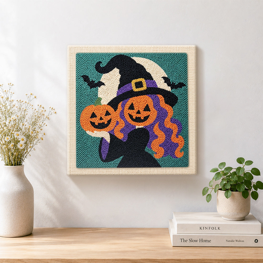Finished witch with pumpkin heads artwork displayed on a wall