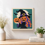 Finished witch with pumpkin heads artwork displayed on a wall