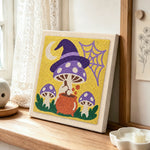 Witchy mushrooms punch needle artwork displayed on a table