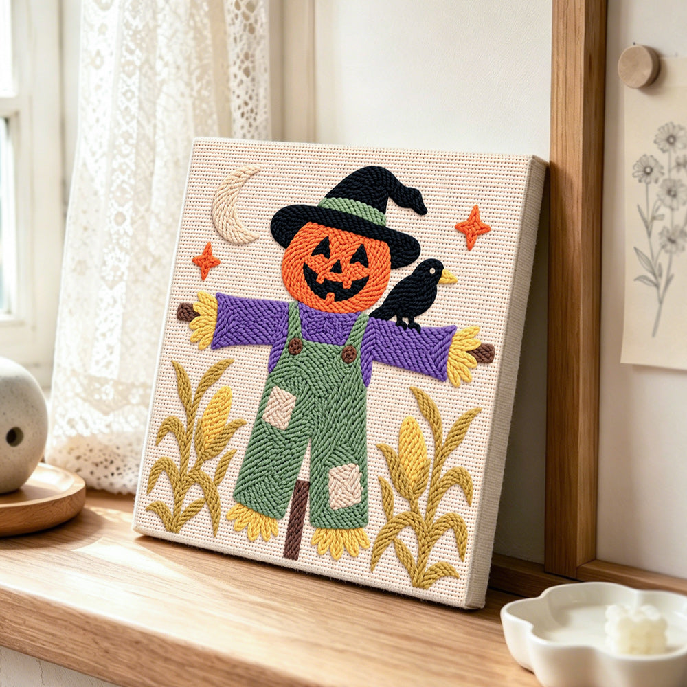 Witchy pumpkin scarecrow punch needle artwork displayed on a table