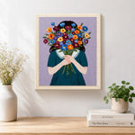 Finished woman holding flowers face hidden artwork displayed on a wall